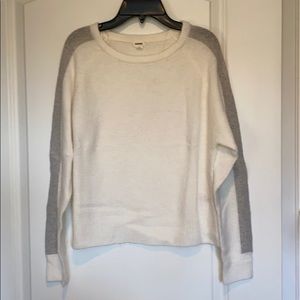 white sweater with gray stripe on sleeves